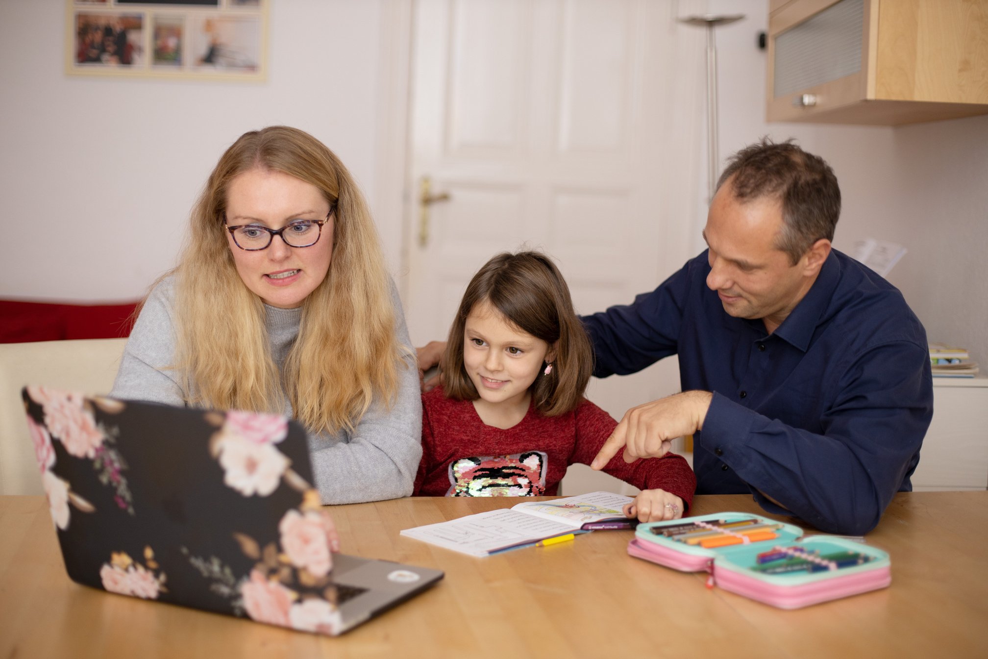 Parents Helping Their Daughter with Home Schooling